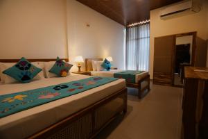 A bed or beds in a room at Coop Safari Hotel