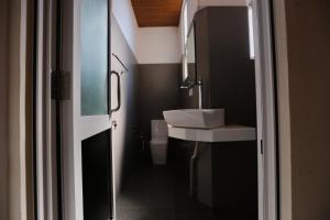 a bathroom with a sink and a toilet in it at Coop Safari Hotel in Tissamaharama