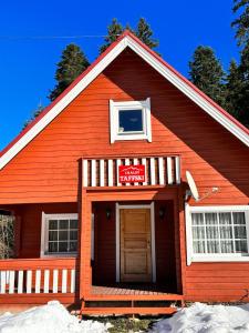 ein rotes Gebäude mit einem Schild darauf in der Unterkunft Chalet Taffski in Borowez