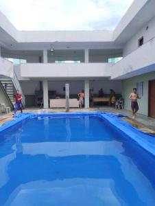 a large blue swimming pool in a building at Casa mobiliada individual in Campinas