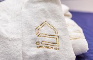 a white towel with a christmas tree on it at SUITE CELESTIA CASORIA By Suite in Casoria