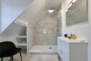 a white bathroom with a shower and a sink at Maddalena - Charming country villa for 10 people in Barneville-la-Bertrand