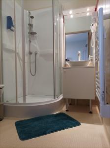 a bathroom with a shower and a sink and a tub at Auberge de Mourjou in Mourjou