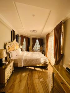 a bedroom with a large bed and a dresser at Burj A Zafar in Murree