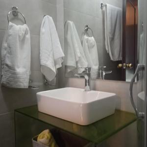 a bathroom with a white sink and towels at Enoro in Pramanta