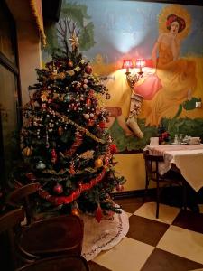 a christmas tree in a room with a table at Chalet Zolota Pidkova in Slavske