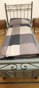 a bed with a black and white blanket on it at Appartamento Rosa in Marghera