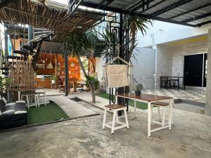 a living room with a table and chairs in a room at Jingle Bells Resort in Ko Larn