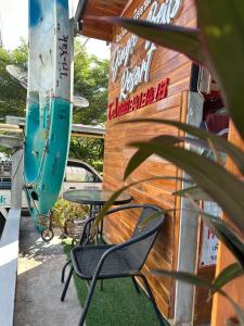 a table and chairs sitting outside of a building at Jingle Bells Resort in Ko Larn