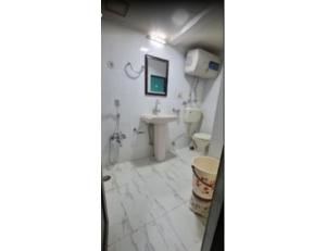 a bathroom with a toilet and a sink at Hotel Basant Inn, Srinagar in Srinagar