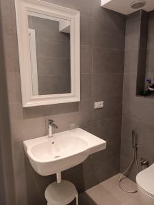 a bathroom with a sink and a mirror at Hotel Due Gemelli in Riomaggiore