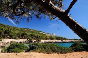 a view of a beach with people in the water at Masseria Vivi il Salento in Santa Caterina di Nardò