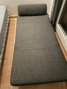 a bed in a room with a grey rug at Exclusive Private Apartment by Warilco - Pleyel 25 m2 - À 1 minute de la station métro Carrefour Pleyel in Saint-Denis