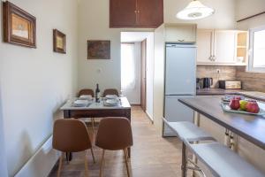 a kitchen with a table and chairs in a kitchen at Era of Elegance: 1928 Classic Dwelling in Tripolis