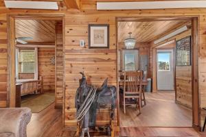 un soggiorno con una parete in legno e una sala da pranzo di Rock Face Lodge a Custer