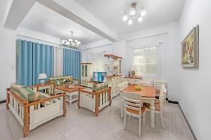a kitchen with a dining room with a table and chairs at XICHI Homestay in Jinning