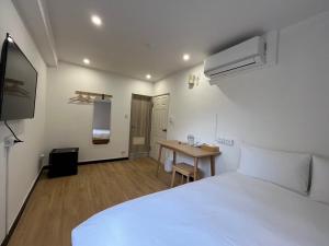 Postel nebo postele na pokoji v ubytování 宏洲旅社HZ Hotel