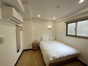 Postel nebo postele na pokoji v ubytování 宏洲旅社HZ Hotel + 25 fotografií