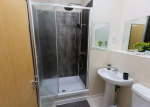 a bathroom with a shower and a sink at Stay at Waltz Gate in Horley