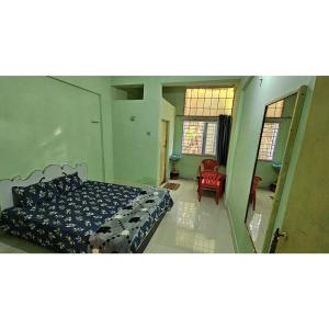 a bedroom with a bed and a living room at Hotel HillView, Junagadh in Junagadh