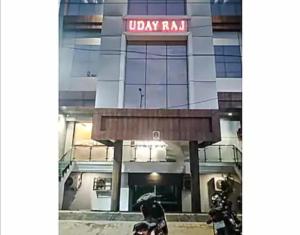 a man riding a motorcycle in front of a building at HOTEL UDAY RAJ in Agra