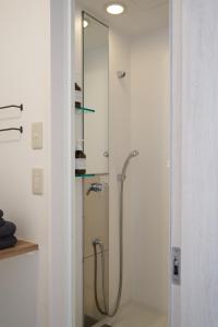 a shower in a bathroom with a glass door at minato hotel in Kyoto