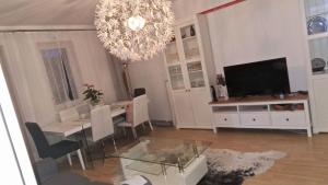 a living room with a table and a chandelier at Ferienwohnung in Erlauf