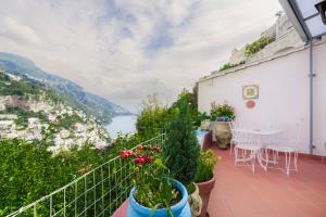 a balcony with a table and chairs and a view at Casa Danira - Positano in Positano +21 photos