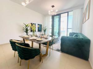 a dining room with a table and some chairs at 2BR,Direct to Dubai mall, Burj Khalifa52 in Dubai