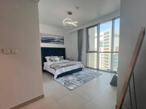 a bedroom with a bed and a large window at 2BR,Direct to Dubai mall, Burj Khalifa52 in Dubai