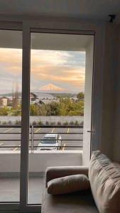 a room with a sliding glass door with a view of a car at Depto. con Vista al Volcan in Villarrica