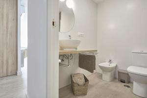 een witte badkamer met een wastafel en een toilet bij Mirador Suite in Alicante