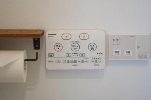 a control panel on the wall of a bathroom at minato hotel in Kyoto