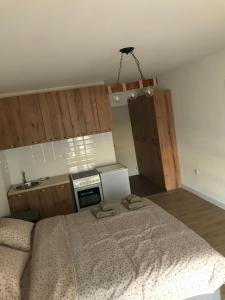 a bedroom with a bed with two towels on it at Apartman Ika 4N in Kraljevo +5 photos