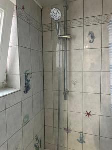 a shower with a shower head in a bathroom at Ferienhaus in einem Wohngebiet bei Frankfurt in Nidderau