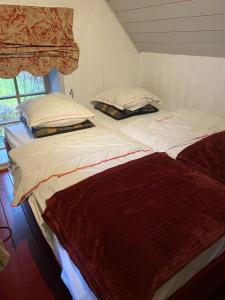 Giường trong phòng chung tại La Maisonnette des Hêtres Rouges