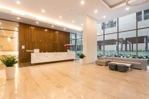 a lobby with a reception desk in a building at Anthesis Riverside Apartment - Masteri Millennium in Ho Chi Minh City