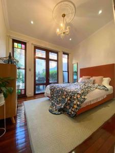 a bedroom with a bed in a room with windows at Immaculate 3 Bed City Home - Close to Everything! in Sydney