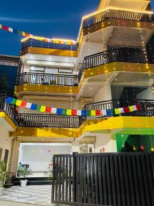 a large building with colorful stairs on it at wuiD stayin wakeupinDoon in Dehradun