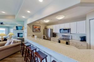 a kitchen and living room with a large counter top at Waters Edge in Lake Ozark