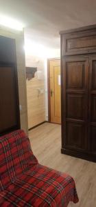 a room with a bed and a wooden door at CASA MIRTILLO sci ai piedi in Prato Nevoso