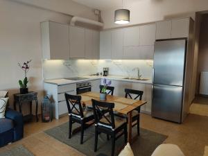 a kitchen with a table and chairs and a refrigerator at The Watch Tower A in Siátista +23 photos