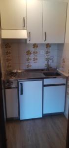 a kitchen with a stove and a sink with blue lights at CASA MIRTILLO sci ai piedi in Prato Nevoso