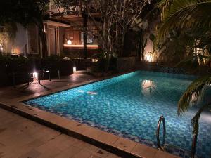 a swimming pool at night in a hotel at Regato Suites in Jakarta