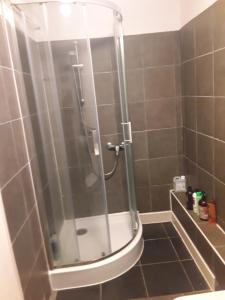 a shower with a glass door in a bathroom at Robs Place, Liverpool in Liverpool