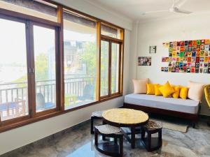 a living room with a couch and a table at wuiD stayin wakeupinDoon in Dehradun