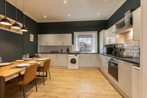a large kitchen with a table and chairs in it at Home in Kelso Scottish Borders in Kelso