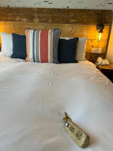 a remote control sitting on top of a bed at The Randolph Hotel in Southwold