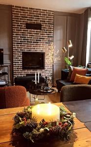 a living room with a candle on a table at Duplex LE GLENCOE in Honfleur