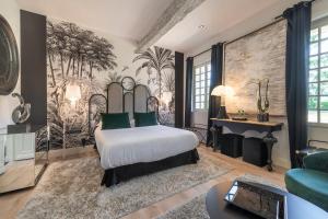 a bedroom with a bed and a wall mural at Château de la Ronde in Vivy +46 photos